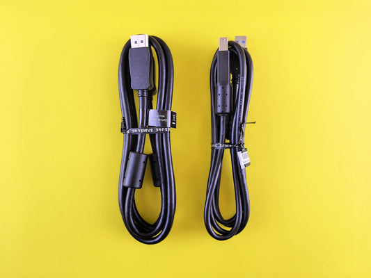 Two black cables coiled on a yellow background